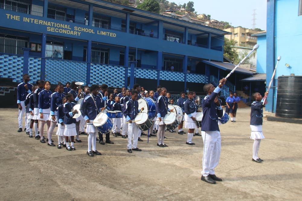 A teacher supporting a student at The International School Limited